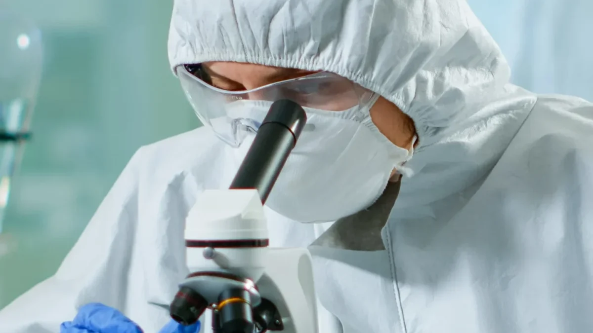 a specialist testing in a lab under microscope
